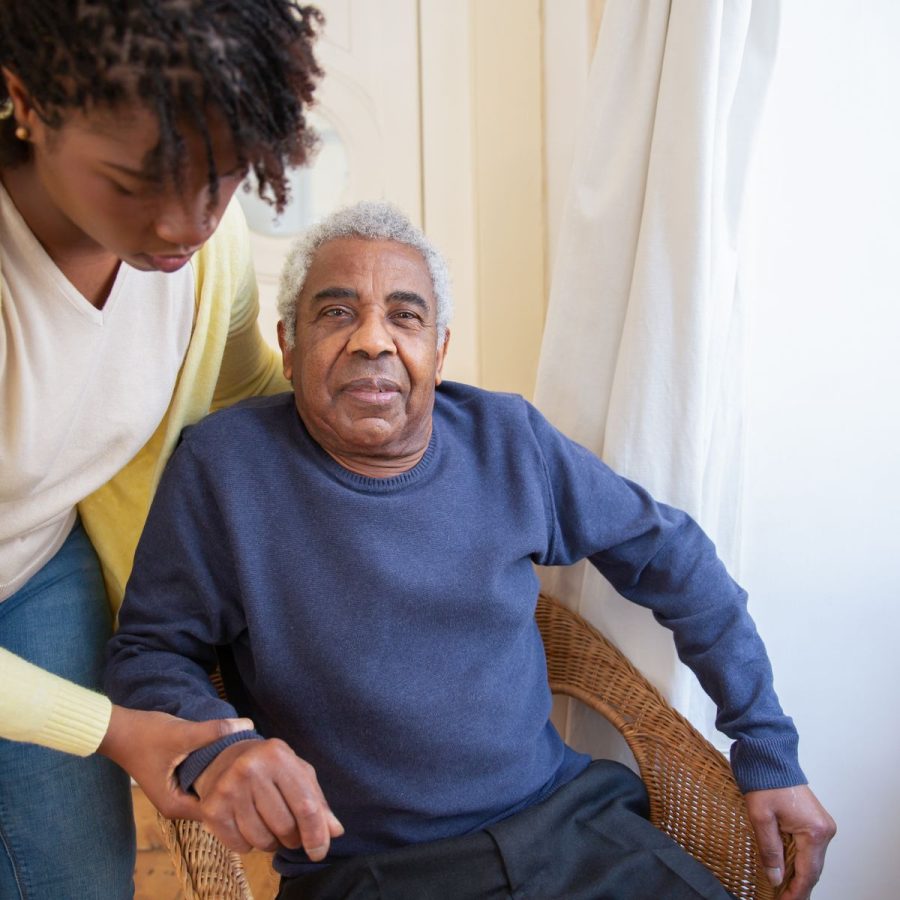 Caregiver helping a senior woman at home