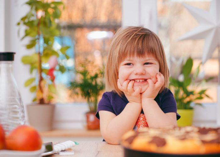 Toddler playing at home with a babysitter