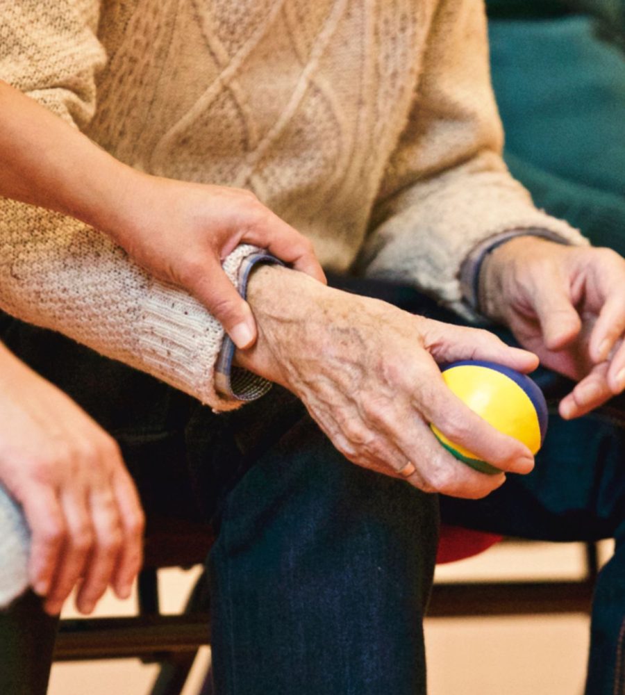 Caregiver holding the hands of a senior woman